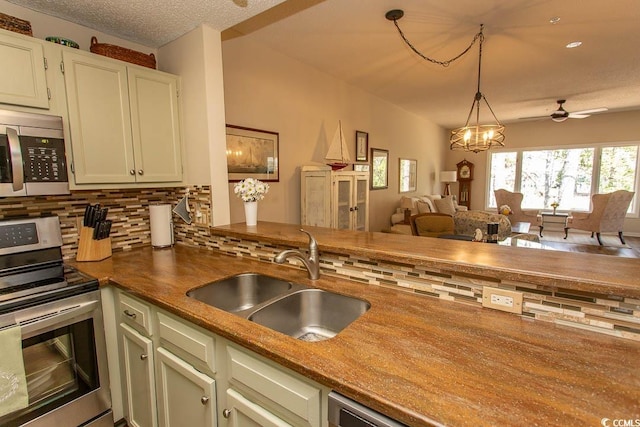 1221 Tidewater Dr Unit 1922, North Myrtle Beach, SC 29582 - kitchen with appliances with stainless steel finishes, a sink, tasteful backsplash, open floor plan, and pendant lighting