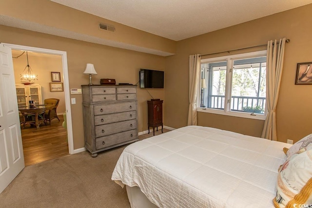 1221 Tidewater Dr Unit 1922, North Myrtle Beach, SC 29582 - bedroom featuring a chandelier, carpet, and baseboards