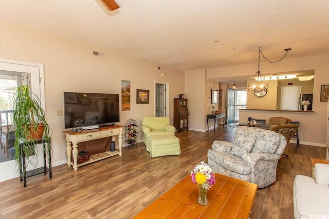 1221 Tidewater Dr Unit 1922, North Myrtle Beach, SC 29582 - living room featuring wood finished floors, baseboards, and a textured ceiling