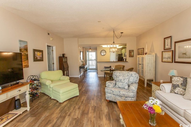 1221 Tidewater Dr Unit 1922, North Myrtle Beach, SC 29582 - living room with a chandelier, wood finished floors, a textured ceiling, and baseboards