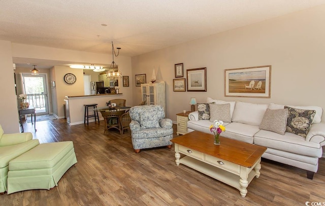 1221 Tidewater Dr Unit 1922, North Myrtle Beach, SC 29582 - living area featuring wood finished floors, a chandelier, and baseboards