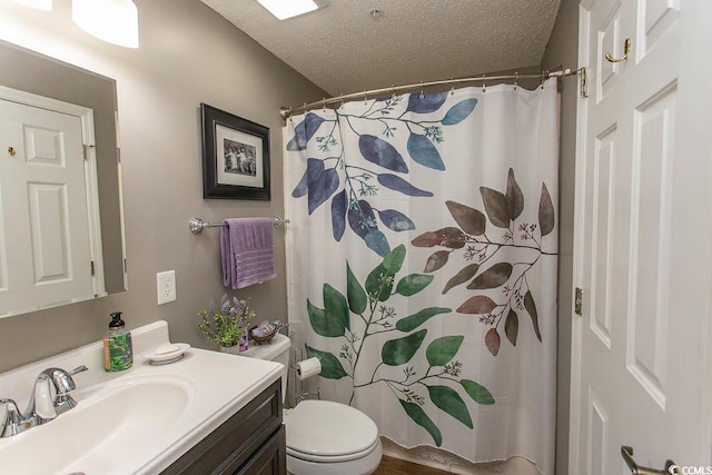 1221 Tidewater Dr Unit 1922, North Myrtle Beach, SC 29582 - full bathroom featuring a textured ceiling, vanity, toilet, and a shower with shower curtain