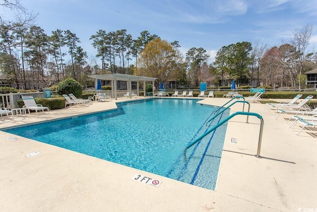 1221 Tidewater Dr Unit 1922, North Myrtle Beach, SC 29582 - community pool featuring a pergola, a patio, fence, and view of wooded area