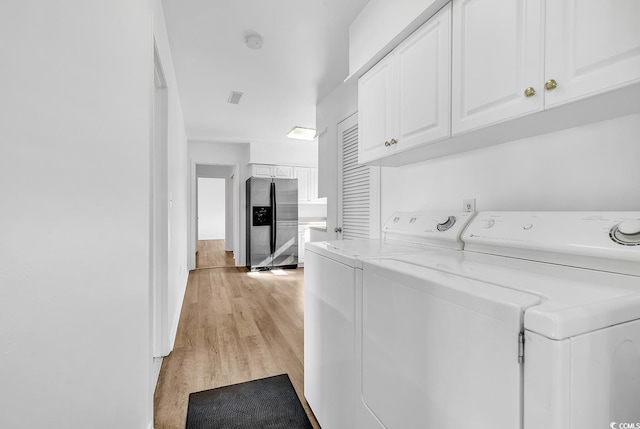 3783 Vine St Unit 3783, Myrtle Beach, SC 29577 - laundry area featuring light wood finished floors, cabinet space, and separate washer and dryer