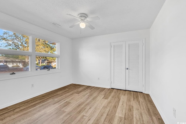 3783 Vine St Unit 3783, Myrtle Beach, SC 29577 - unfurnished bedroom with baseboards, a textured ceiling, visible vents, a closet, and wood finished floors