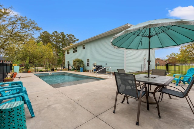 view of swimming pool with fence, a fenced in pool, and a patio