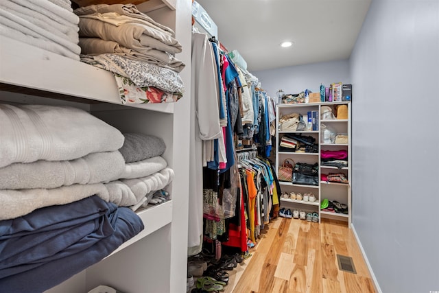 walk in closet with visible vents and wood finished floors