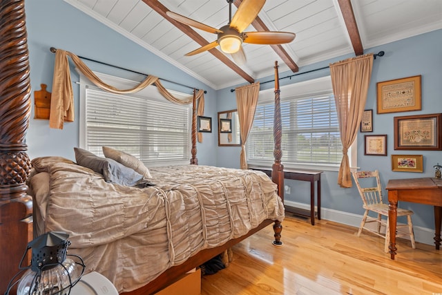 bedroom with wood ceiling, multiple windows, vaulted ceiling with beams, and wood finished floors