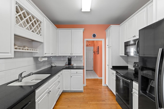 808 Arbor Ln, North Myrtle Beach, SC 29582 - kitchen featuring refrigerator with ice dispenser, black / electric stove, dishwasher, dark countertops, and white cabinets