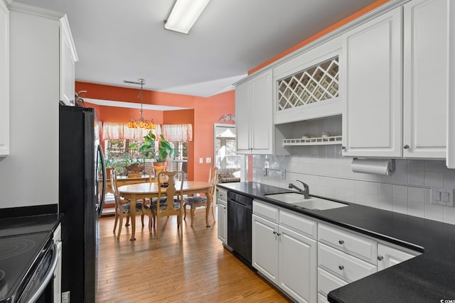 808 Arbor Ln, North Myrtle Beach, SC 29582 - kitchen featuring dark countertops, dishwasher, freestanding refrigerator, and decorative backsplash