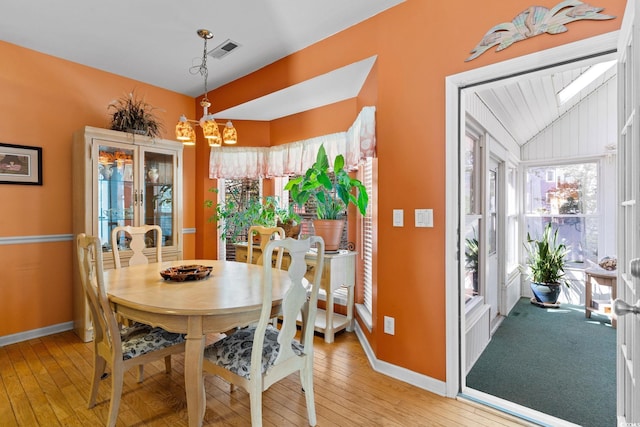 808 Arbor Ln, North Myrtle Beach, SC 29582 - dining space featuring lofted ceiling, a chandelier, healthy amount of natural light, and light wood finished floors