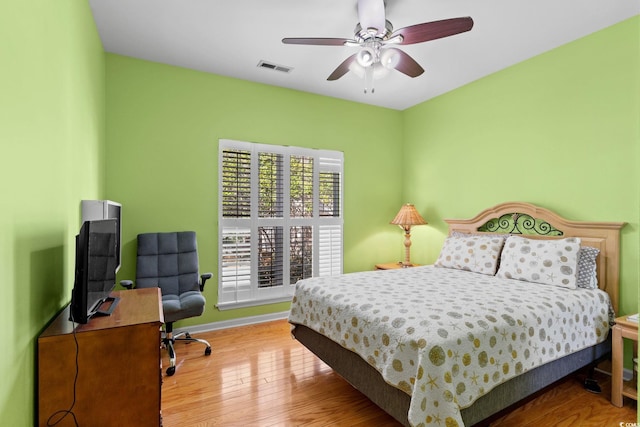 808 Arbor Ln, North Myrtle Beach, SC 29582 - bedroom with wood finished floors, an office area, and a ceiling fan