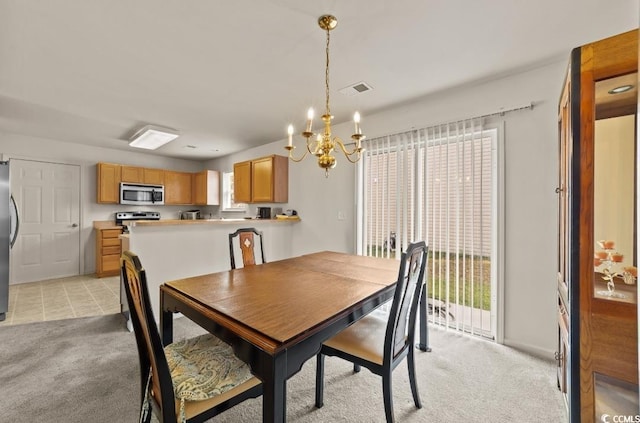 dining room with visible vents, a chandelier, and light colored carpet