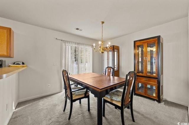 dining space featuring light carpet, baseboards, a notable chandelier, and visible vents