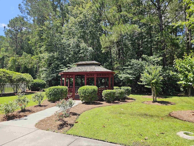 view of front facade featuring fence, a front lawn, and a gazebo