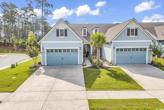 view of front of house featuring driveway, a front yard, a garage, and board and batten siding