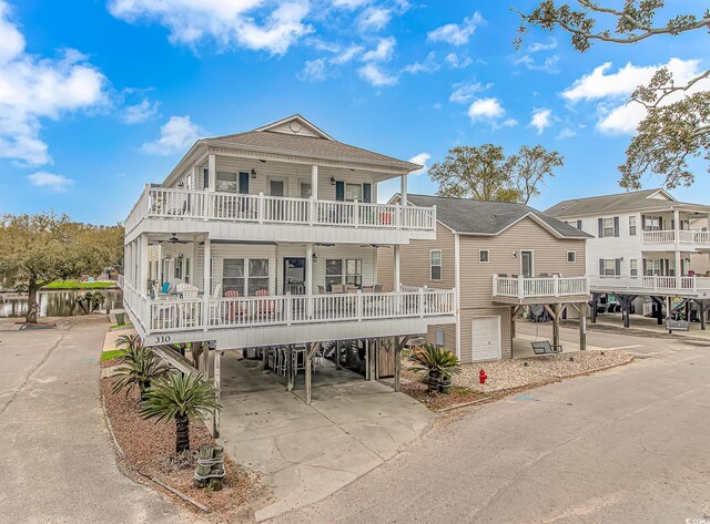 6001-310 S Kings Hwy, Myrtle Beach, SC 29575 - view of front of property featuring a balcony, a carport, concrete driveway, ceiling fan, and a shingled roof