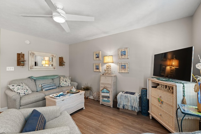living room featuring ceiling fan and wood finished floors