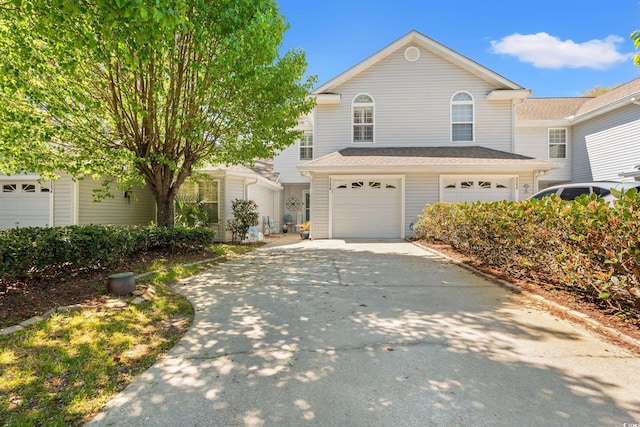 traditional-style house featuring driveway and an attached garage
