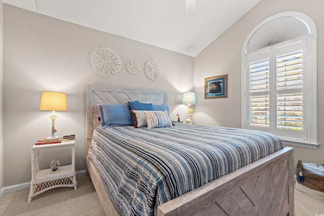 carpeted bedroom featuring baseboards and vaulted ceiling