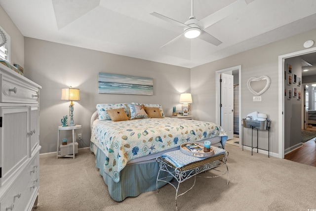 bedroom featuring baseboards, a ceiling fan, and light colored carpet