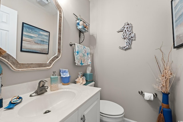 bathroom with toilet and vanity