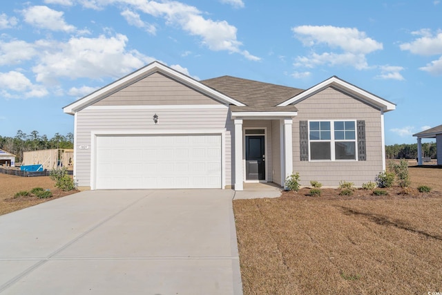 ranch-style home with concrete driveway and an attached garage