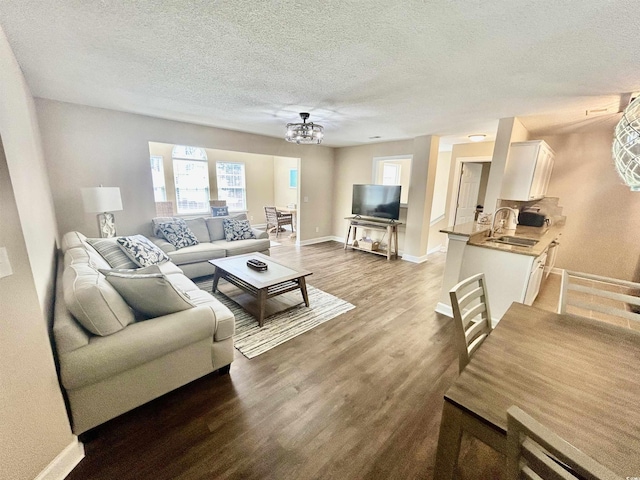 4370 Crepe Myrtle Ct Unit F, Murrells Inlet, SC 29576 - living area featuring a chandelier, a textured ceiling, wood finished floors, and baseboards