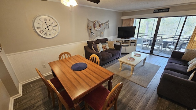 415 Ocean Creek Dr Unit 2443, Myrtle Beach, SC 29572 - living room featuring a wainscoted wall, ceiling fan, dark wood-type flooring, a textured ceiling, and crown molding