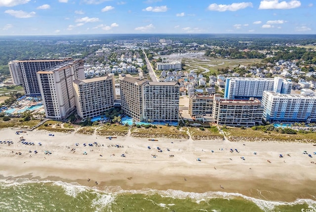 aerial view with a beach view, a water view, and a city view