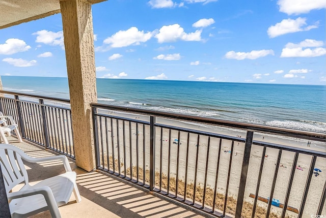 balcony with a view of the beach and a water view