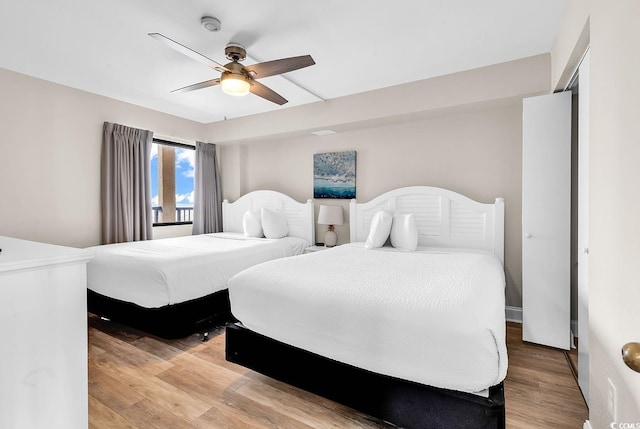 bedroom with light wood-style flooring and ceiling fan