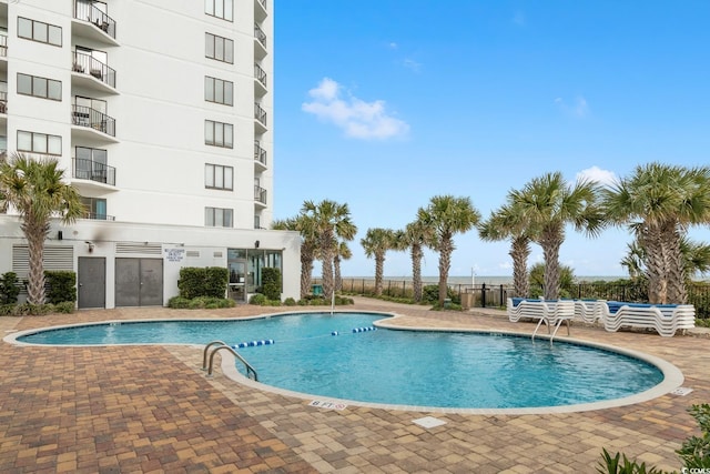 pool featuring a patio and fence