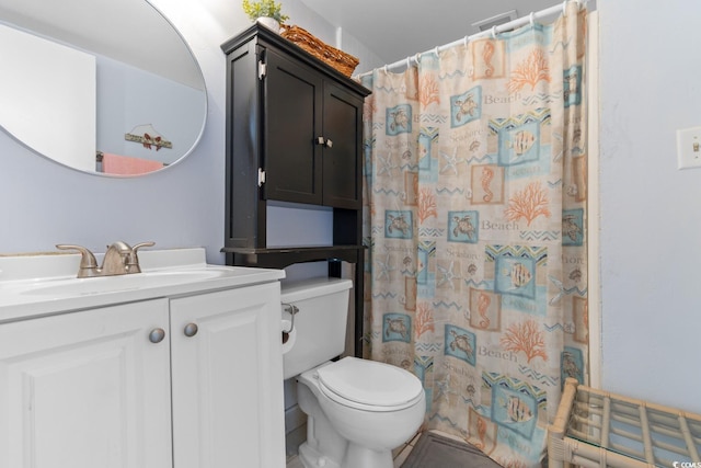 bathroom featuring vanity, toilet, and a shower with shower curtain