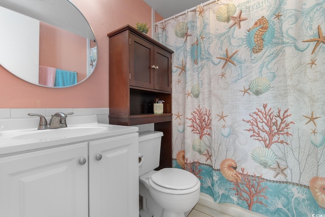 bathroom with vanity, a shower with shower curtain, and toilet
