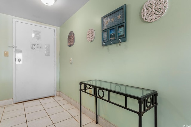 interior space with baseboards and tile patterned flooring