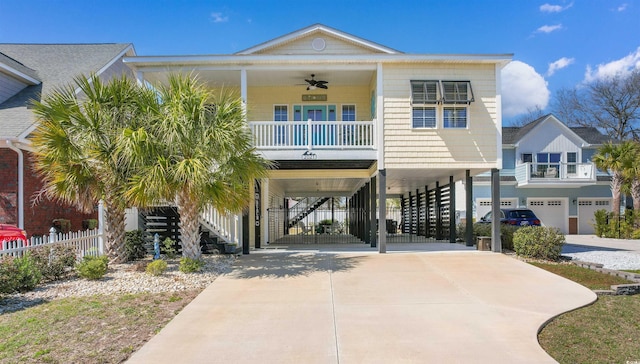 2021 Ye Olde Kings Hwy, North Myrtle Beach, SC 29582 - coastal home with driveway, covered porch, stairway, a carport, and ceiling fan