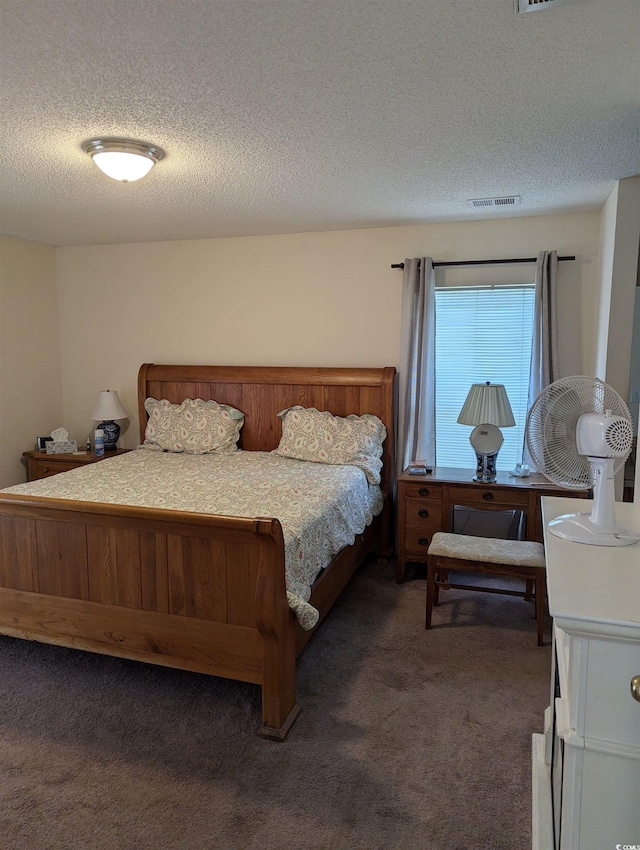 bedroom with carpet flooring and a textured ceiling