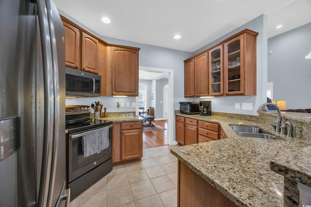 124 Mesa Raven Dr, Longs, SC 29568 - kitchen featuring a sink, glass insert cabinets, black appliances, and light stone counters