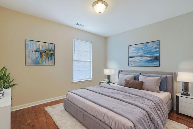bedroom with dark wood-style flooring and baseboards