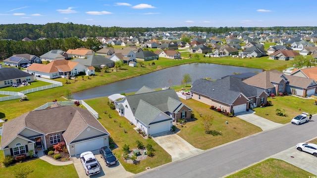drone / aerial view with a water view and a residential view