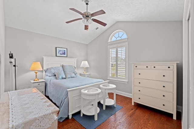 bedroom featuring visible vents, baseboards, dark wood-type flooring, and lofted ceiling