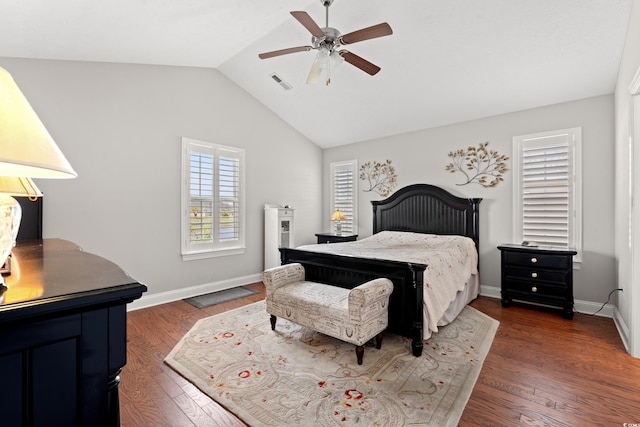 bedroom with ceiling fan, visible vents, vaulted ceiling, baseboards, and dark wood-style floors