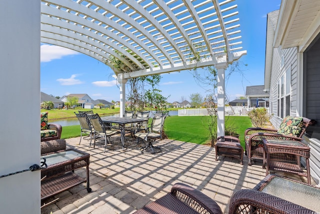 view of patio with fence, a pergola, outdoor dining area, a water view, and a residential view