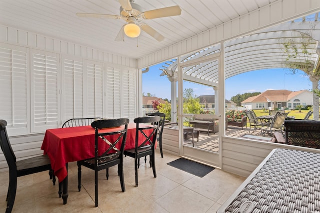 sunroom / solarium featuring a ceiling fan, outdoor dining space, and an outdoor living space