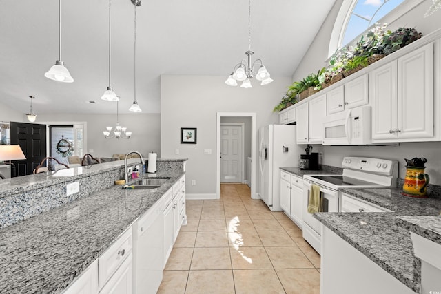kitchen featuring hanging light fixtures, a sink, white cabinets, a chandelier, and white appliances