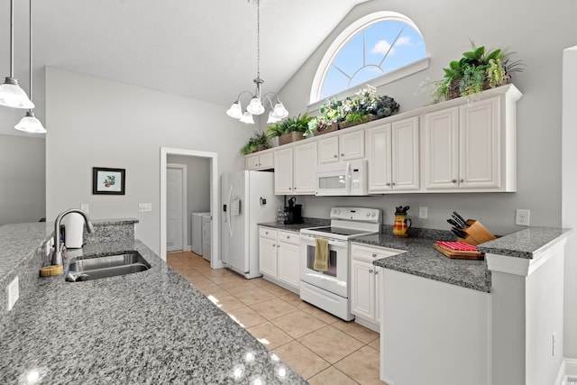 kitchen featuring light tile patterned flooring, white appliances, white cabinetry, washing machine and clothes dryer, and a sink