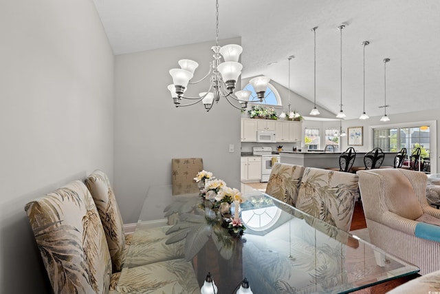 dining space featuring baseboards, a notable chandelier, and lofted ceiling