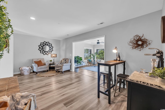 living area featuring recessed lighting, ceiling fan, visible vents, and light wood finished floors