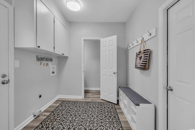 washroom featuring cabinet space, baseboards, light wood-style flooring, and hookup for a washing machine